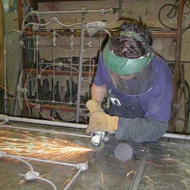 Cathouse Employee grinding welds for smooth transistion